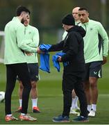 18 March 2024; Technical advisor Brian Kerr hands a bib to Finn Azaz during a Republic of Ireland training session at the FAI National Training Centre in Abbotstown, Dublin. Photo by Stephen McCarthy/Sportsfile