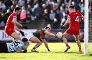 17 March 2024; Diarmuid Baker of Derry, 4, saves from Tommy Conroy of Mayo during the Allianz Football League Division 1 match between Mayo and Derry at Hastings Insurance MacHale Park in Castlebar, Mayo. Photo by Piaras Ó Mídheach/Sportsfile
