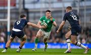 16 March 2024; Calvin Nash of Ireland in action against Ben White, left, and Stafford McDowall of Scotland during the Guinness Six Nations Rugby Championship match between Ireland and Scotland at the Aviva Stadium in Dublin. Photo by Sam Barnes/Sportsfile