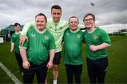 19 March 2024; Republic of Ireland's Seamus Coleman with, from left, Hughie Sweeney, from Gweedore, Donegal, Daniel O'Reilly, from Letterkenny, Donegal, and David Crawford, from Donegal Town, of the Ireland Down Syndrome Futsal squad on a visit to a Republic of Ireland training session at the FAI National Training Centre in Abbotstown, Dublin. Photo by Stephen McCarthy/Sportsfile