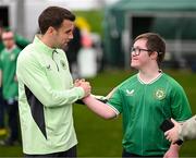 19 March 2024; Republic of Ireland's Seamus Coleman with David Crawford, from Donegal Town, of the Ireland Down Syndrome Futsal squad on a visit to a Republic of Ireland training session at the FAI National Training Centre in Abbotstown, Dublin. Photo by Stephen McCarthy/Sportsfile