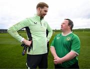 19 March 2024; Republic of Ireland goalkeeper Caoimhin Kelleher with Hughie Sweeney, from Gweedore, Donegal, of the Ireland Down Syndrome Futsal squad on a visit to a Republic of Ireland training session at the FAI National Training Centre in Abbotstown, Dublin. Photo by Stephen McCarthy/Sportsfile
