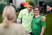 19 March 2024; Republic of Ireland's Seamus Coleman with David Crawford, from Donegal Town, of the Ireland Down Syndrome Futsal squad on a visit to a Republic of Ireland training session at the FAI National Training Centre in Abbotstown, Dublin. Photo by Stephen McCarthy/Sportsfile