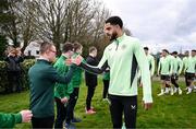 19 March 2024; Republic of Ireland's Andrew Omobamidele meets members of the Ireland Down Syndrome Futsal squad on a visit to a Republic of Ireland training session at the FAI National Training Centre in Abbotstown, Dublin. Photo by Stephen McCarthy/Sportsfile