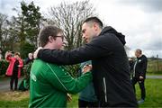 19 March 2024; Republic of Ireland analyst Stephen Rice meets David Crawford, from Donegal Town, of the Ireland Down Syndrome Futsal squad on a visit to a Republic of Ireland training session at the FAI National Training Centre in Abbotstown, Dublin. Photo by Stephen McCarthy/Sportsfile