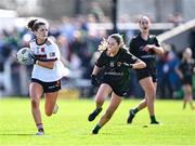 20 March 2024; Eve Boyle Carr of St Columba's Comprehensive School in action against Amy O'Connor of Dunmore Community School during the Lidl LGFA All-Ireland Post Primary School Senior C Championship final match between St Columba's Comprehensive School of Glenties, Donegal, and Dunmore Community School in Galway at Kilcoyne Park in Tubbercurry, Sligo. Photo by Piaras Ó Mídheach/Sportsfile