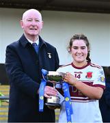 20 March 2024; St Columba's Comprehensive School captain Mia Bennett is presented with the cup by Connacht LGFA president Brendan Cregg after the Lidl LGFA All-Ireland Post Primary School Senior C Championship final match between St Columba's Comprehensive School of Glenties, Donegal, and Dunmore Community School in Galway at Kilcoyne Park in Tubbercurry, Sligo. Photo by Piaras Ó Mídheach/Sportsfile