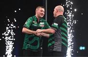 21 March 2024; Nathan Aspinall, left, and Rob Cross embrace after their match at the BetMGM Premier League Darts at the 3Arena in Dublin. Photo by Ben McShane/Sportsfile