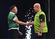 21 March 2024; Gerwyn Price, left, shakes hands with Michael van Gerwen after their match at the BetMGM Premier League Darts at the 3Arena in Dublin. Photo by Ben McShane/Sportsfile