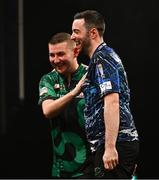 21 March 2024; Luke Humphries, right, and Nathan Aspinall after their semi-final match at the BetMGM Premier League Darts at the 3Arena in Dublin. Photo by Ben McShane/Sportsfile
