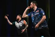 21 March 2024; Luke Humphries, right, and Michael Smith in action during their final match at the BetMGM Premier League Darts at the 3Arena in Dublin. Photo by Ben McShane/Sportsfile