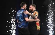 21 March 2024; Luke Humphries and Michael Smith embrace after their final match at the BetMGM Premier League Darts at the 3Arena in Dublin. Photo by Ben McShane/Sportsfile