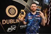 21 March 2024; Luke Humphries celebrates with the trophy after winning his final match against Michael Smith at the BetMGM Premier League Darts at the 3Arena in Dublin. Photo by Ben McShane/Sportsfile