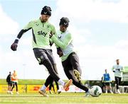 22 March 2024; Goalkeeper Caoimhin Kelleher and Chiedozie Ogbene, right, during a Republic of Ireland training session at the FAI National Training Centre in Abbotstown, Dublin. Photo by Stephen McCarthy/Sportsfile