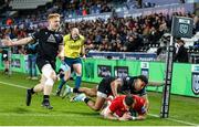 22 March 2024; Shane Daly of Munster scores his side's first try despite the efforts of Keelan Giles of Ospreys during the United Rugby Championship match between Ospreys and Munster at the Swansea.com Stadium in Swansea, Wales. Photo by Gruffydd Thomas/Sportsfile