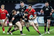 22 March 2024; Tom Ahern is tackled by Alex Cuthbert of Ospreys during the United Rugby Championship match between Ospreys and Munster at the Swansea.com Stadium in Swansea, Wales. Photo by Chris Fairweather/Sportsfile