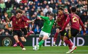 23 March 2024; Evan Ferguson of Republic of Ireland in action against Wout Faes, left, and Aster Vranckx of Belgium during the international friendly match between Republic of Ireland and Belgium at the Aviva Stadium in Dublin. Photo by Stephen McCarthy/Sportsfile