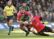 23 March 2024; Conor Oliver of Connacht is tackled by Etienne Oosthuizen, 4, and JP Smith of Emirates Lions uring the United Rugby Championship match between Connacht and Emirates Lions at Dexcom Stadium in Galway. Photo by Piaras Ó Mídheach/Sportsfile
