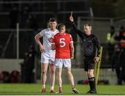 23 March 2024; Referee Joe McQuillan shows a yellow card to Alex Beirne of Kildare and Conall McKeever of Louth during the Allianz Football League Division 2 match between Kildare and Louth at Netwatch Cullen Park in Carlow. Photo by Michael P Ryan/Sportsfile