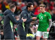 23 March 2024; Sammie Szmodics of Republic of Ireland with assistant coach Paddy McCarthy and assistant coach Glenn Whelan, left, during the international friendly match between Republic of Ireland and Belgium at the Aviva Stadium in Dublin. Photo by Stephen McCarthy/Sportsfile