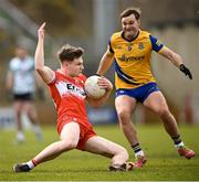 24 March 2024; Ethan Doherty of Derry in action against Ultan Harney of Roscommon during the Allianz Football League Division 1 match between Derry and Roscommon at Celtic Park in Derry. Photo by Ramsey Cardy/Sportsfile