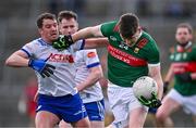 24 March 2024; James Carr of Mayo is tackled by Ryan Wylie of Monaghan during the Allianz Football League Division 1 match between Monaghan and Mayo at St Tiernach's Park in Clones, Monaghan. Photo by Ben McShane/Sportsfile