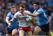 24 March 2024; Seanie O'Donnell of Tyrone is tackled by Cian Lynch, left, and Theo Clancy of Dublin during the Allianz Football League Division 1 match between Dublin and Tyrone at Croke Park in Dublin. Photo by Shauna Clinton/Sportsfile