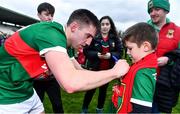 24 March 2024; Enda Hession of Mayo signs a jersey for Mayo supporter Michael Walsh, age 10, from Ballycastle, after the Allianz Football League Division 1 match between Monaghan and Mayo at St Tiernach's Park in Clones, Monaghan. Photo by Ben McShane/Sportsfile