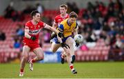 24 March 2024; Cian Connolly of Roscommon in action against Conor McCluskey of Derry during the Allianz Football League Division 1 match between Derry and Roscommon at Celtic Park in Derry. Photo by Ramsey Cardy/Sportsfile