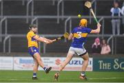 24 March 2024; David Reidy of Clare scores a point despite the efforts of Ronan Maher of Tipperary during the Allianz Hurling League Division 1 semi-final match between Clare and Tipperary at Laois Hire O'Moore Park in Portlaoise, Laois. Photo by John Sheridan/Sportsfile