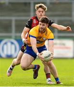 24 March 2024; Ronan Lanigan of Clare in action against John McGovern of Down during the Allianz Football League Division 3 match between Down and Clare at Páirc Esler in Newry, Down. Photo by Matt Browne/Sportsfile