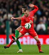 26 March 2024; Silvan Widmer of Switzerland in action against Robbie Brady of Republic of Ireland during the international friendly match between Republic of Ireland and Switzerland at the Aviva Stadium in Dublin. Photo by Stephen McCarthy/Sportsfile