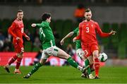 26 March 2024; Silvan Widmer of Switzerland in action against Mikey Johnston and Robbie Brady of Republic of Ireland during the international friendly match between Republic of Ireland and Switzerland at the Aviva Stadium in Dublin. Photo by Ben McShane/Sportsfile