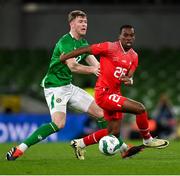26 March 2024; Derek Kutesa of Switzerland is tackled by Nathan Collins of Republic of Ireland during the international friendly match between Republic of Ireland and Switzerland at the Aviva Stadium in Dublin. Photo by Stephen McCarthy/Sportsfile