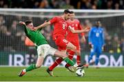 26 March 2024; Remo Freuler of Switzerland is tackled by Evan Ferguson of Republic of Ireland during the international friendly match between Republic of Ireland and Switzerland at the Aviva Stadium in Dublin. Photo by David Fitzgerald/Sportsfile