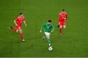 26 March 2024; Mikey Johnston of Republic of Ireland in action against Switzerland players from left, Remo Freuler, and Silvan Widmer during the international friendly match between Republic of Ireland and Switzerland at the Aviva Stadium in Dublin. Photo by Michael P Ryan/Sportsfile
