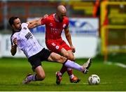29 March 2024; Mark Coyle of Shelbourne is tackled by Robbie Benson of Dundalk during the SSE Airtricity Men's Premier Division match between Shelbourne and Dundalk at Tolka Park in Dublin. Photo by Tyler Miller/Sportsfile