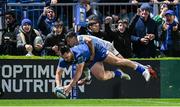 29 March 2024; James Lowe of Leinster dives over to score his side's third try, despite the tackle of Embrose Papier of Vodacom Bulls, during the United Rugby Championship match between Leinster and Vodacom Bulls at the RDS Arena in Dublin. Photo by Harry Murphy/Sportsfile