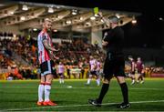 29 March 2024; Mark Connolly of Derry City remonstrates with referee Declan Toland as he is issued a yellow card during the SSE Airtricity Men's Premier Division match between Derry City and Galway United at The Ryan McBride Brandywell Stadium in Derry. Photo by Ben McShane/Sportsfile