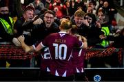 29 March 2024; Stephen Walsh of Galway United, hidden, celebrates with teammates David Hurley, 10, and Edward McCarthy, and supporters after scoring their side's first goal during the SSE Airtricity Men's Premier Division match between Derry City and Galway United at The Ryan McBride Brandywell Stadium in Derry. Photo by Ben McShane/Sportsfile