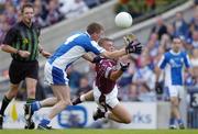 24 July 2004; Alan Mangan, Westmeath, is tackled by Laois' Paul McDonald. Bank of Ireland Leinster Senior Football Championship Final Replay, Westmeath v Laois, Croke Park, Dublin. Picture credit; Ray McManus / SPORTSFILE