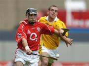 25 July 2004; Ben O'Connor, Cork, is tackled by Antrim's Johnny Campbell. Guinness All-Ireland Senior Hurling Championship, Quarter Final, Antrim v Cork, Croke Park, Dublin. Picture credit; Brian Lawless / SPORTSFILE
