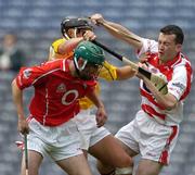 25 July 2004; Donal Og Cusack, Cork, supported by Brian Murphy, is tackled by Antrim's Brian McFall. Guinness All-Ireland Senior Hurling Championship, Quarter Final, Antrim v Cork, Croke Park, Dublin. Picture credit; Ray McManus / SPORTSFILE