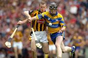 25 July 2004; Niall Gilligan, Clare, is tackled by Kilkenny's Tommy Walsh. Guinness All-Ireland Senior Hurling Championship, Quarter Final, Clare v Kilkenny, Croke Park, Dublin. Picture credit; Ray McManus / SPORTSFILE