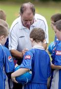 27 July 2004; Republic of Ireland manager Brian Kerr signs autographs while he attended the FAI Pepsi Summer Soccer School in Palmerstown Rangers Club, Dublin. Picture credit; Damien Eagers / SPORTSFILE