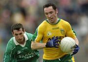 24 July 2004; Brendan Devenney, Donegal, in action against Fermanagh's Raymond Johnson. Bank of Ireland Senior Football Championship Qualifier, Round 4, Fermanagh v Donegal, Tighernach's Park, Clones. Co. Monaghan. Picture credit; Damien Eagers / SPORTSFILE