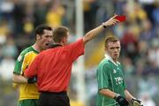 24 July 2004; Donegal's Brendan Devenney is issued the red card by referee Joe McQuillan as Fermanagh's Martin McGrath looks on. Bank of Ireland Senior Football Championship Qualifier, Round 4, Fermanagh v Donegal, Tighernach's Park, Clones. Co. Monaghan. Picture credit; Damien Eagers / SPORTSFILE