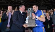 14 September 2013; Clare captain Paul Flanagan is presented with the trophy by Uachtarán Chumann Lúthchleas Gael Liam Ó Néill. Bord Gáis Energy GAA Hurling Under 21 All-Ireland 'A' Championship Final, Antrim v Clare, Semple Stadium, Thurles, Co. Tipperary. Picture credit: Brendan Moran / SPORTSFILE