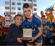 14 September 2013; Donnacha Power, aged 7, from Kilnamona, Co. Clare, presents the Man of the Match award to Clare's Davy O'Halloran. Bord Gáis Energy GAA Hurling Under 21 All-Ireland 'A' Championship Final, Antrim v Clare, Semple Stadium, Thurles, Co. Tipperary. Picture credit: Ray McManus / SPORTSFILE