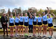 30 March 2024; The UCD Senior Women's team, from left, Tara Phelan, Alison Daly, Sarah Daly, Nell Allison, Libby Ryan, Lauryn Roche, Dervila O’Brien, Jessica Farrell, Niamh Campbell, and coach Tom Sullivan, far left, celebrate with the Corcoran Cup after winning the annual Colours Boat Race between UCD and Trinity College on the River Liffey in Dublin. Photo by Sam Barnes/Sportsfile